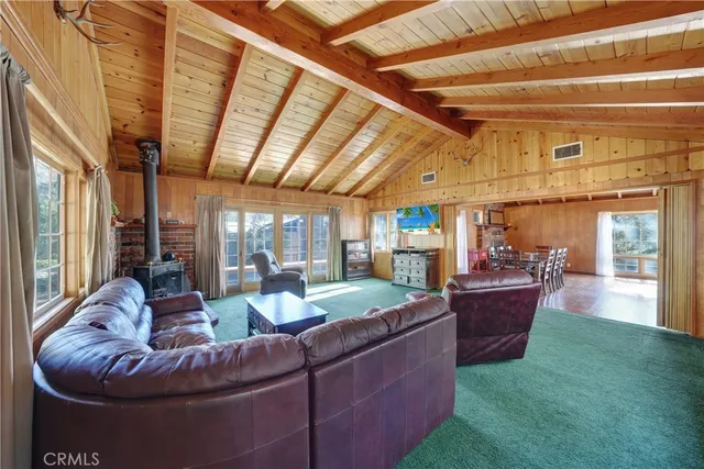 a living room with furniture a piano and a chandelier
