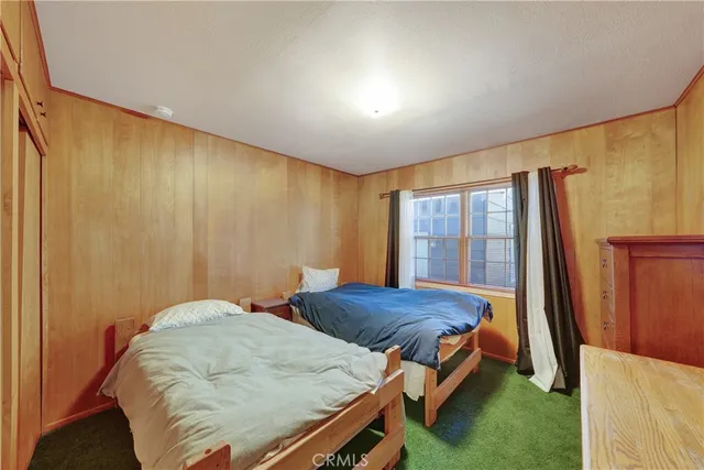 a bedroom with a bed and a view of living room