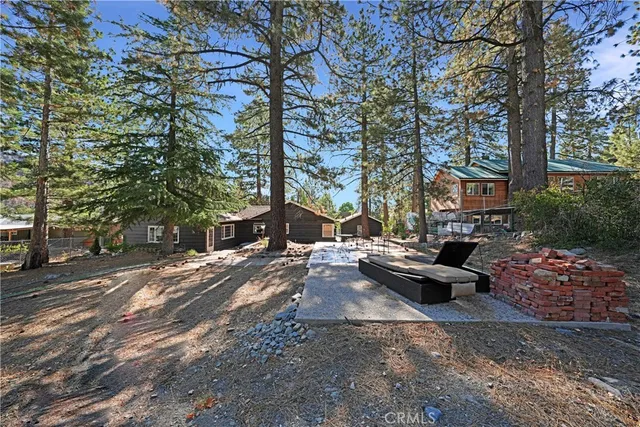 a view of a yard with large trees
