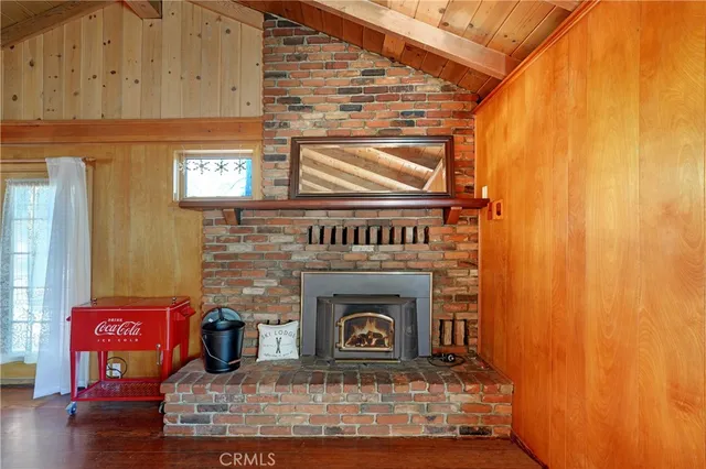 a kitchen with stainless steel appliances a sink a stove top oven a refrigerator cabinets and wooden floor