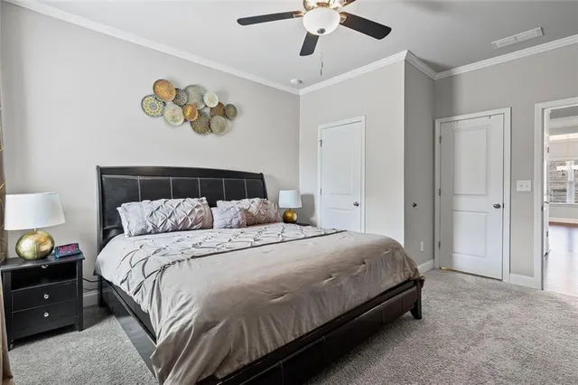 a bedroom with a bed and painting on the wall