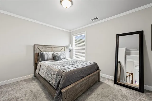 a bed sitting in a bedroom next to a window