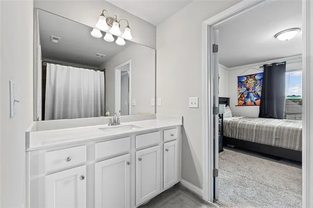 a en suite bathroom with double sink and a mirror