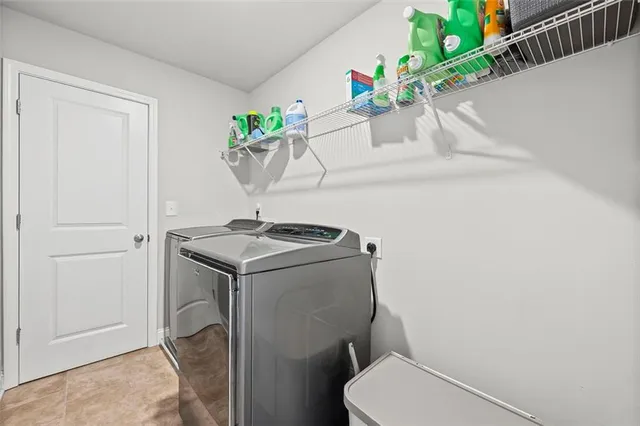 a bedroom with bed and a chandelier