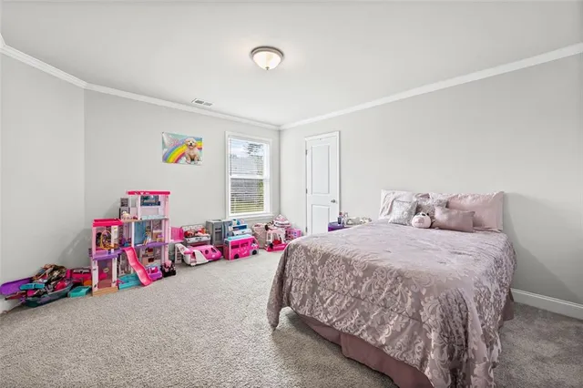 a spacious bedroom with a bed and cabinet