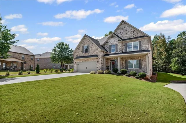 a front view of a house with a yard and garage