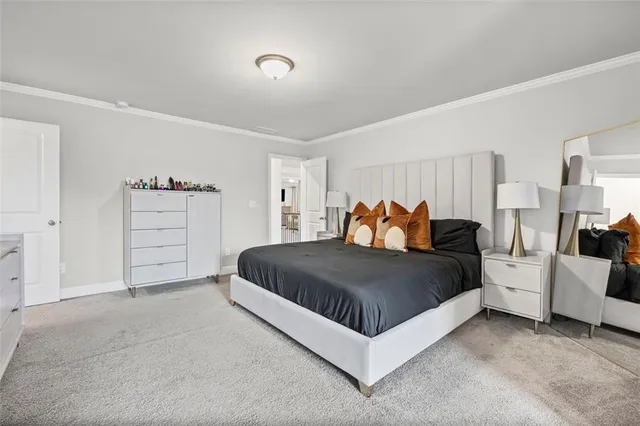 a large bedroom with a large bed and a couch