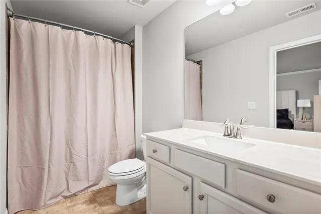 a bedroom with a bed a window and a flat screen television