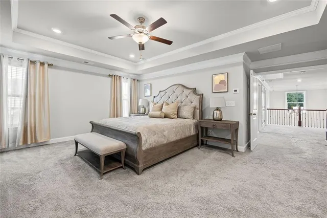 a spacious bedroom with a bed and a ceiling fan