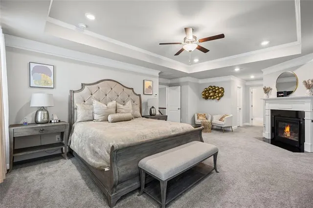 a spacious bedroom with a bed and a flat screen tv