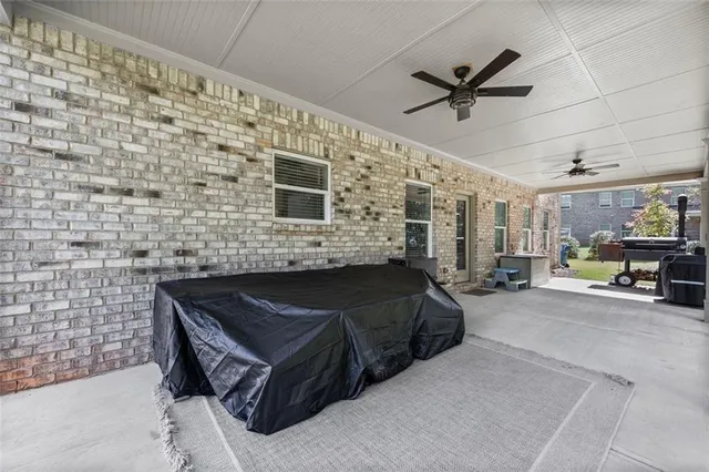 a view of a patio with a table chairs and a yard