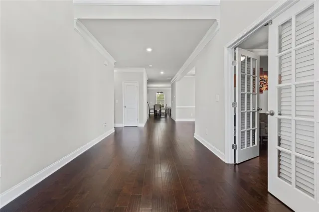 a view of a hallway with wooden floor
