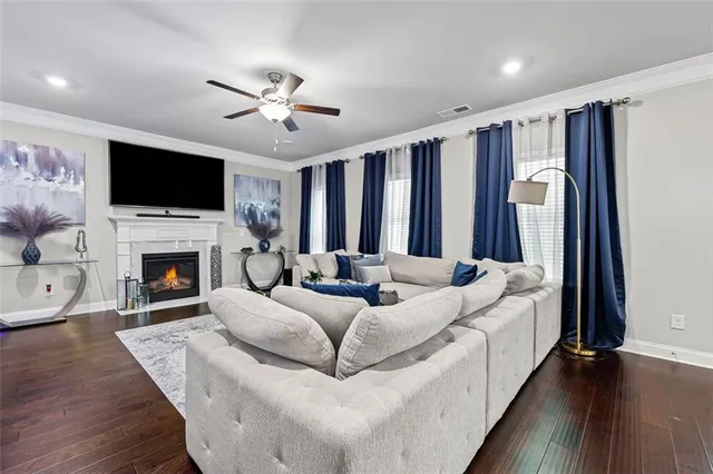 a living room with furniture fireplace and flat screen tv
