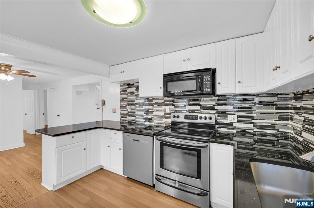 3 Country Club Road Livingston, NJ 07039 - Photo 13 of 37 a kitchen with granite countertop a sink cabinets and stainless steel appliances