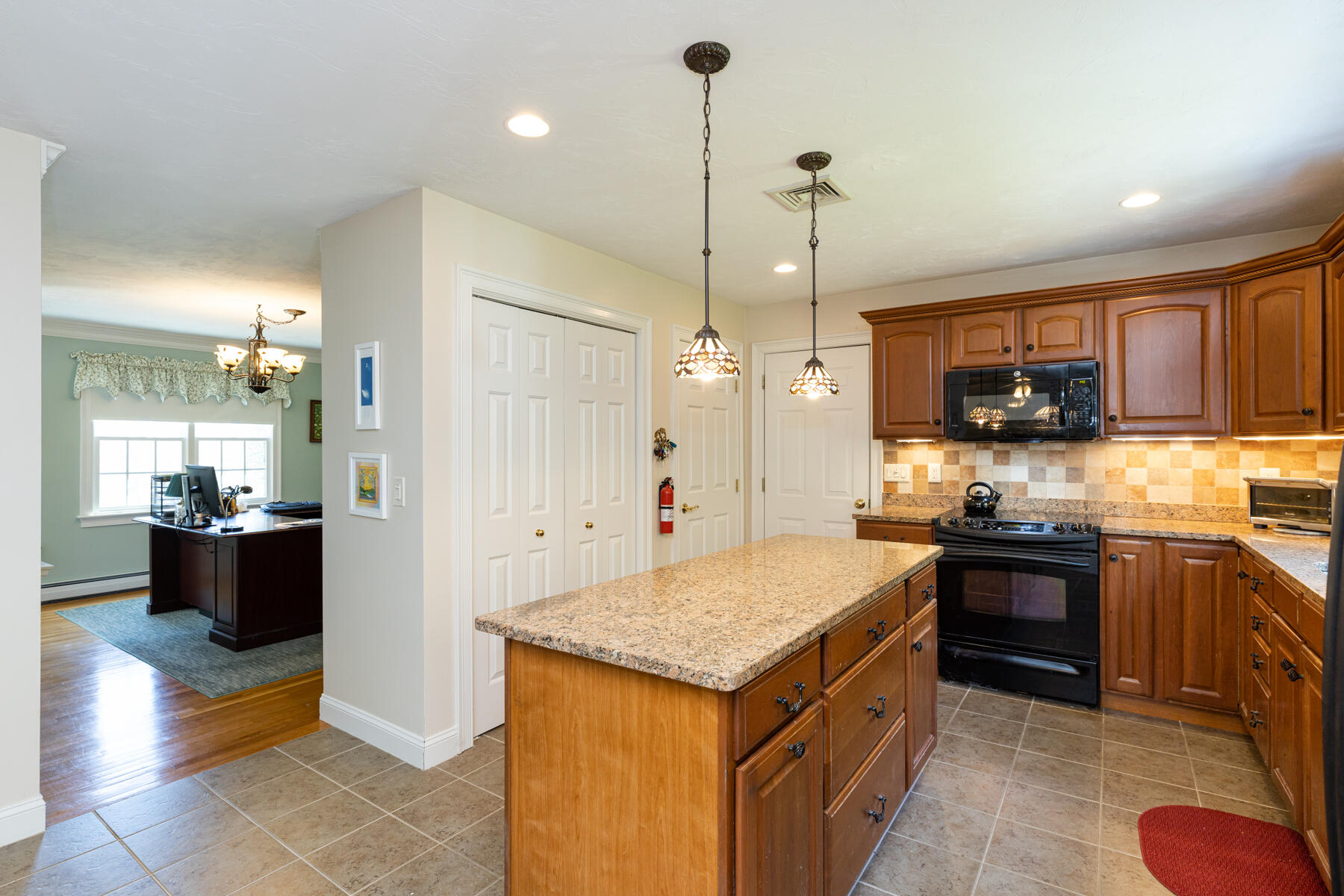 16 Tiffany Road Monument Beach, MA 02532 - Photo 7 of 42 a kitchen with kitchen island granite countertop wooden cabinets and stainless steel appliances