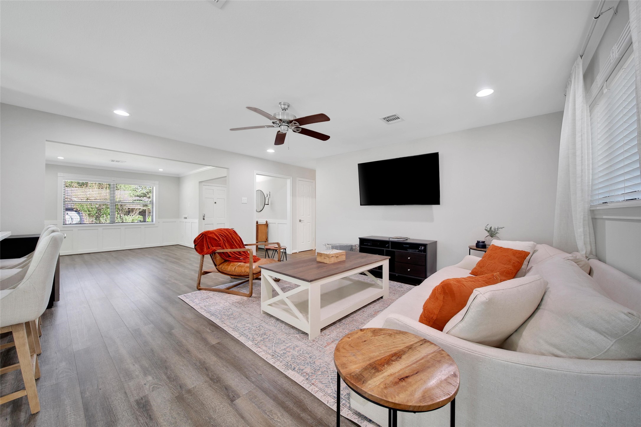 4402 Fallbrook Drive Houston, TX 77018 - Photo 13 of 29 Bright open-concept living room featuring modern finishes, abundant natural light, and direct views into the kitchen and breakfast area.