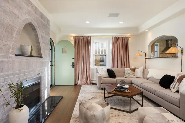 a living room with furniture and a fireplace