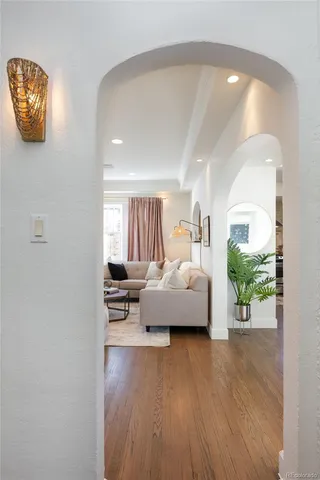 a bedroom with furniture and a wooden floor