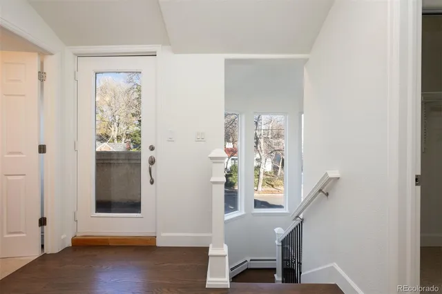 a view of entryway with wooden floor and stairs
