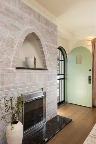 a living room with a fireplace and a potted plant