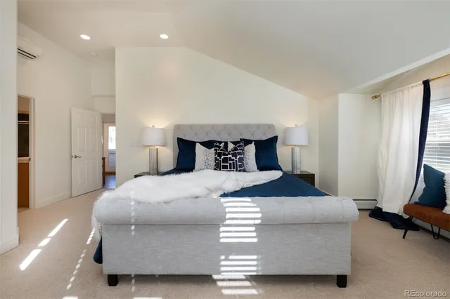 a spacious bedroom with a bed and a couch