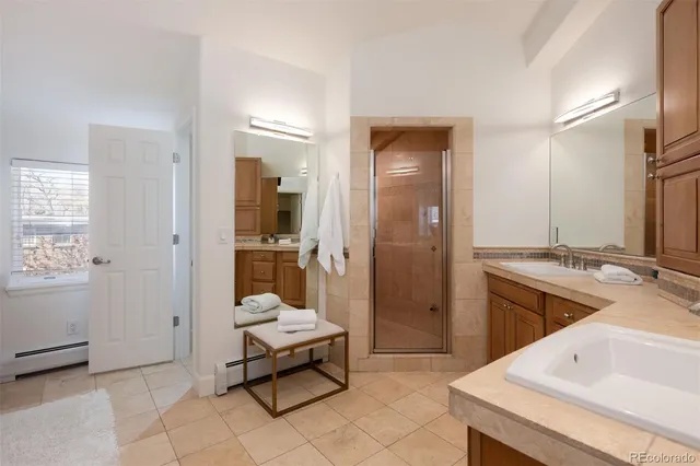 a bathroom with a double vanity sink and a mirror
