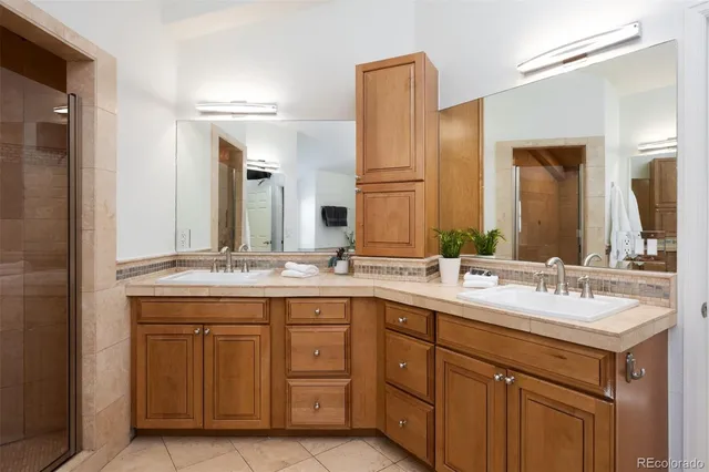 a bathroom with a tub sink and mirror