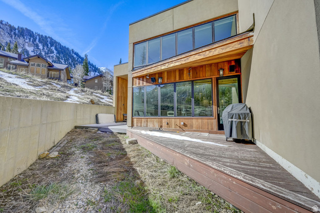9699 Bypass Road, Unit 5 Alta, UT 84092 - Photo 31 of 54 Exterior featuring a multi-level deck, wood siding accents, large windows, and an upper-level window bank