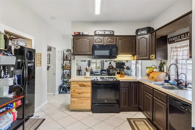 a kitchen with refrigerator and cabinets