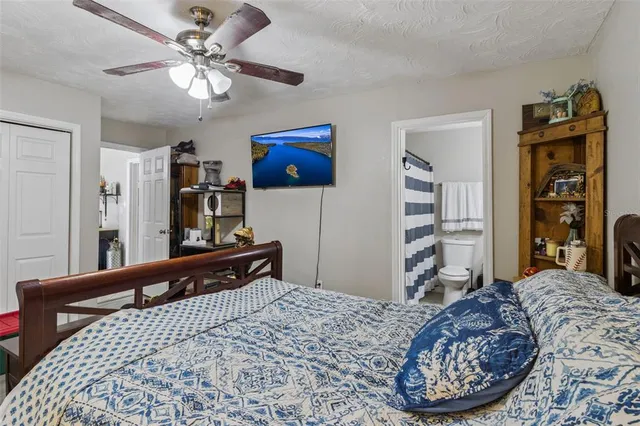 a bedroom with a bed dresser and a large mirror