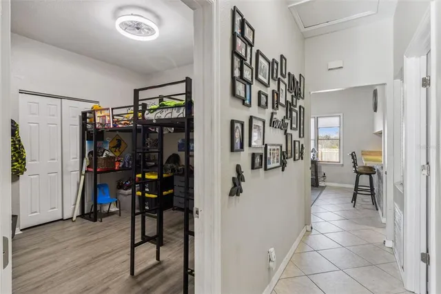 a view of a hallway with wooden floor and windows