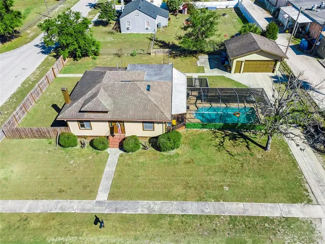 an aerial view of a house having a yard