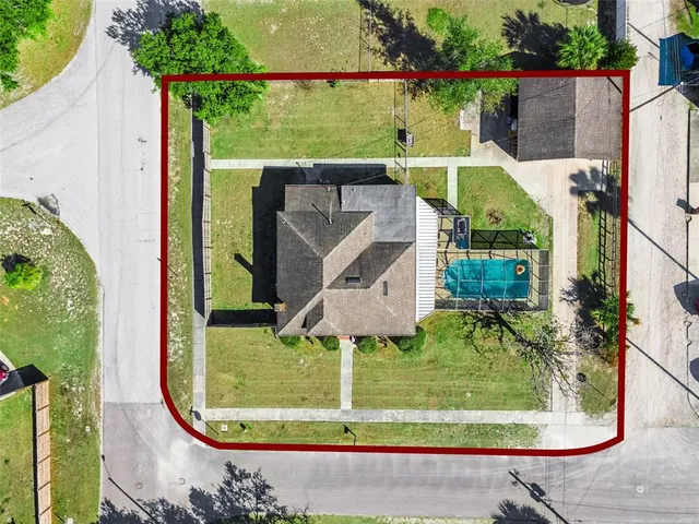 an aerial view of a house with a garden and plants