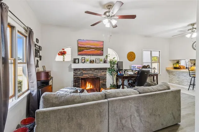 a living room with furniture and a fireplace