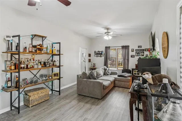 a living room with furniture and a wooden floor