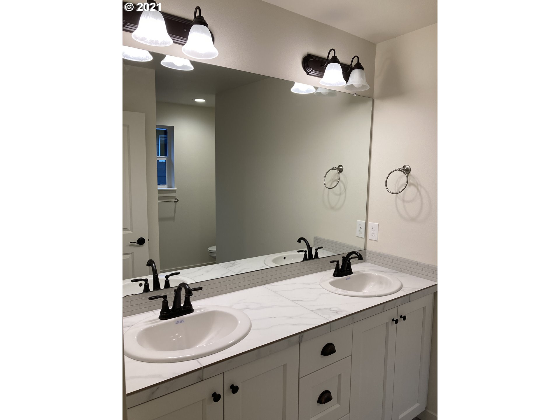 7023 South Ridge Way Ridgefield, WA 98642 - Photo 13 of 13 a bathroom with a sink double vanity and a mirror