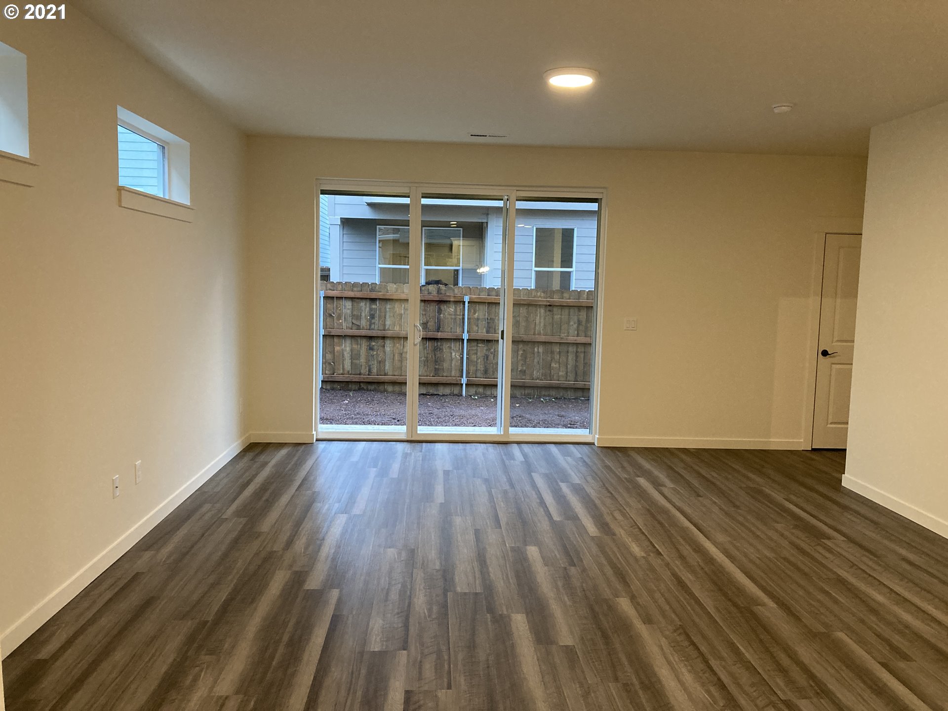 7023 South Ridge Way Ridgefield, WA 98642 - Photo 4 of 13 an empty room with wooden floor and windows
