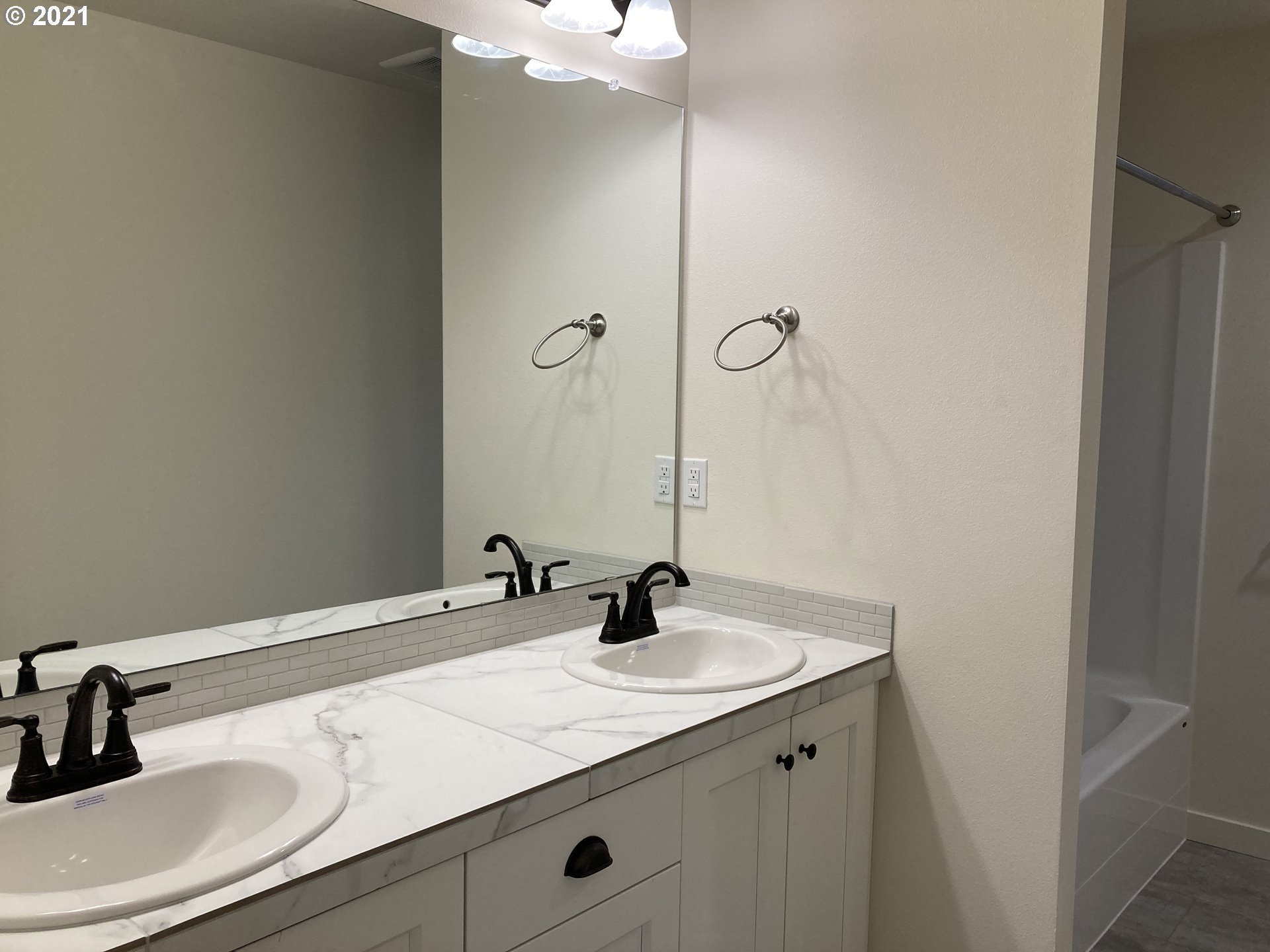 7023 South Ridge Way Ridgefield, WA 98642 - Photo 10 of 13 a bathroom with a sink and a mirror