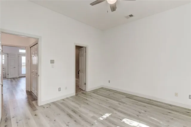 a view of a room with wooden floor