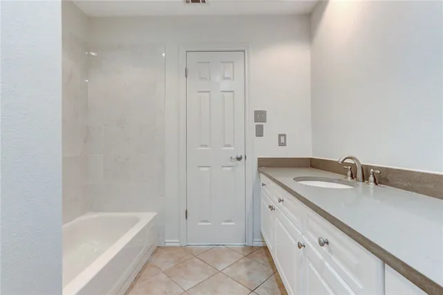 a bathroom with a tub sink and mirror