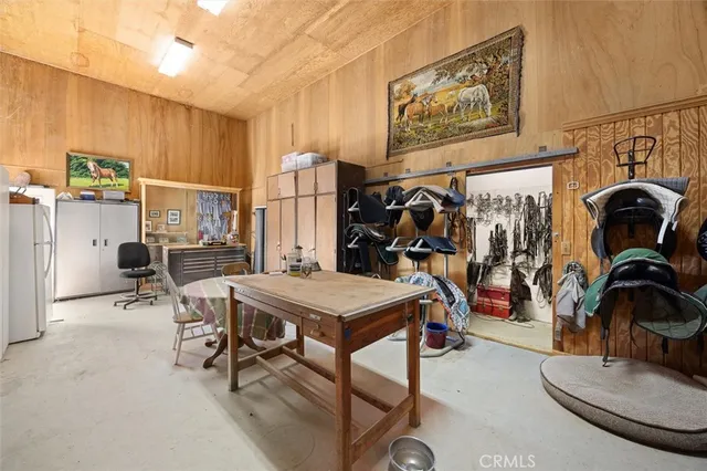 a dining room with furniture a chandelier and wooden floor