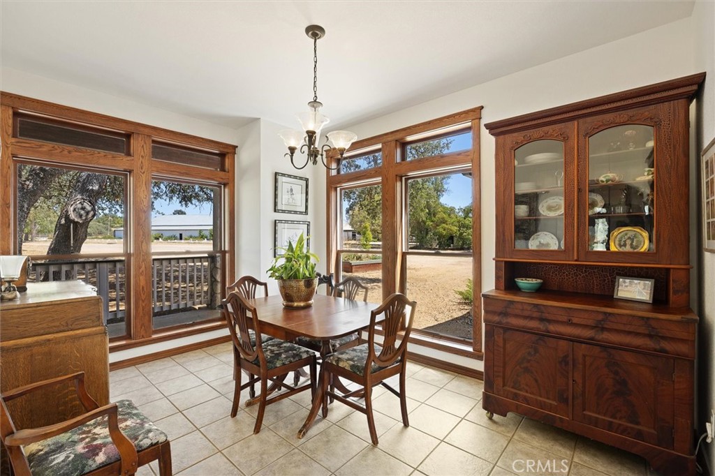 5625 Linne Road Paso Robles, CA 93446 - Photo 29 of 75 a dining room with furniture a chandelier and wooden floor