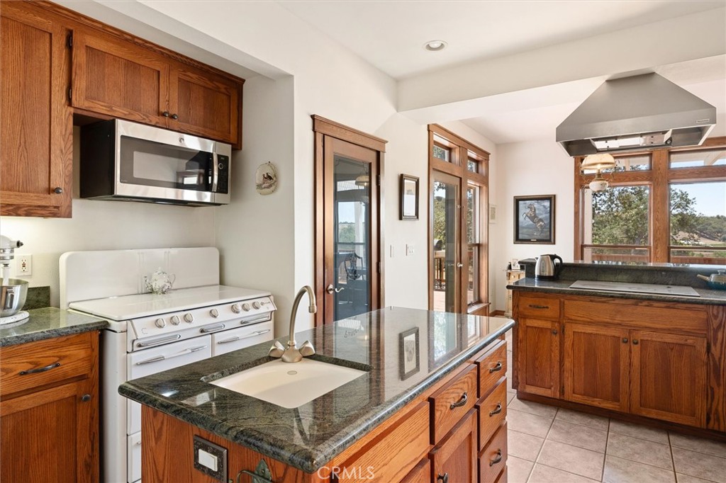 5625 Linne Road Paso Robles, CA 93446 - Photo 30 of 75 a kitchen with stainless steel appliances granite countertop a stove a sink and a microwave