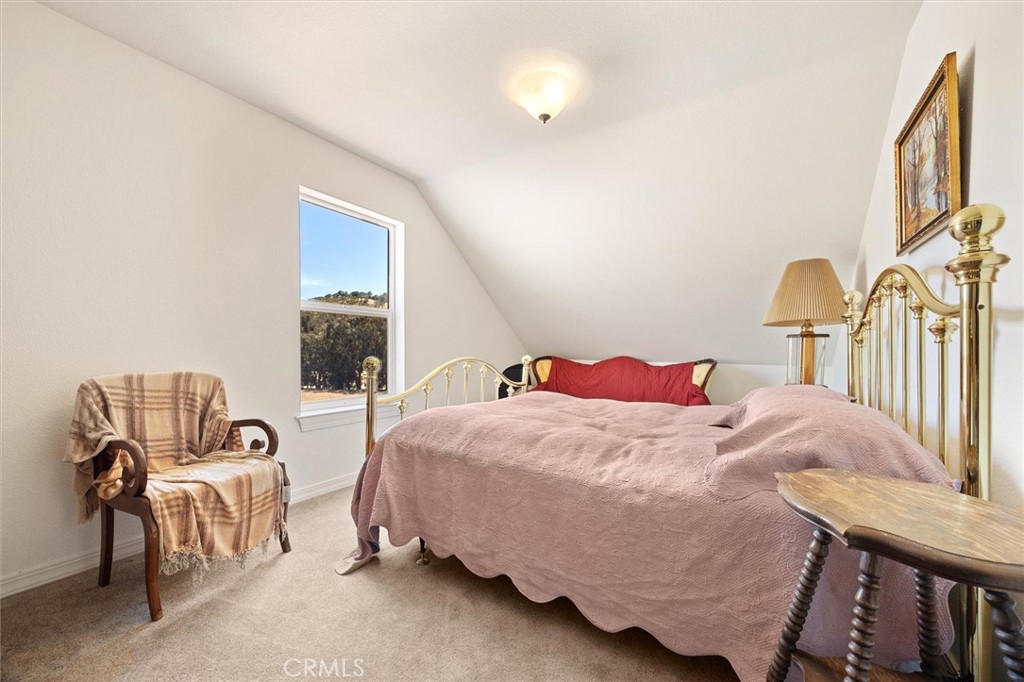 5625 Linne Road Paso Robles, CA 93446 - Photo 42 of 75 a bedroom with a bed and a chandelier