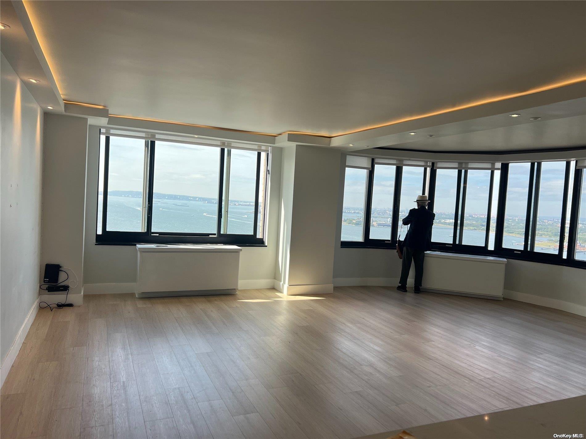 200 Rector Place, Unit 35E Manhattan, NY 10280 - Photo 14 of 33 wooden floor in an empty room with a window