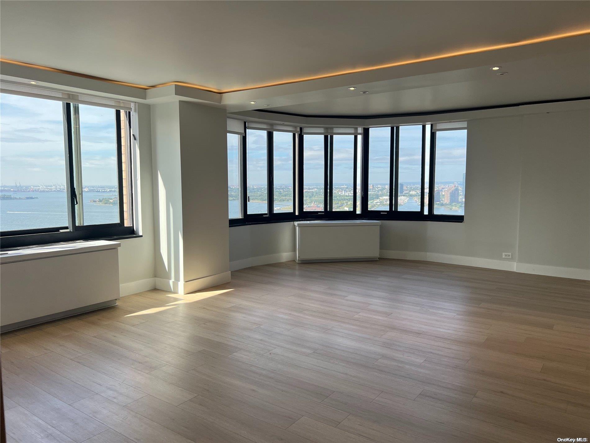 200 Rector Place, Unit 35E Manhattan, NY 10280 - Photo 24 of 33 wooden floor in an empty room with a window