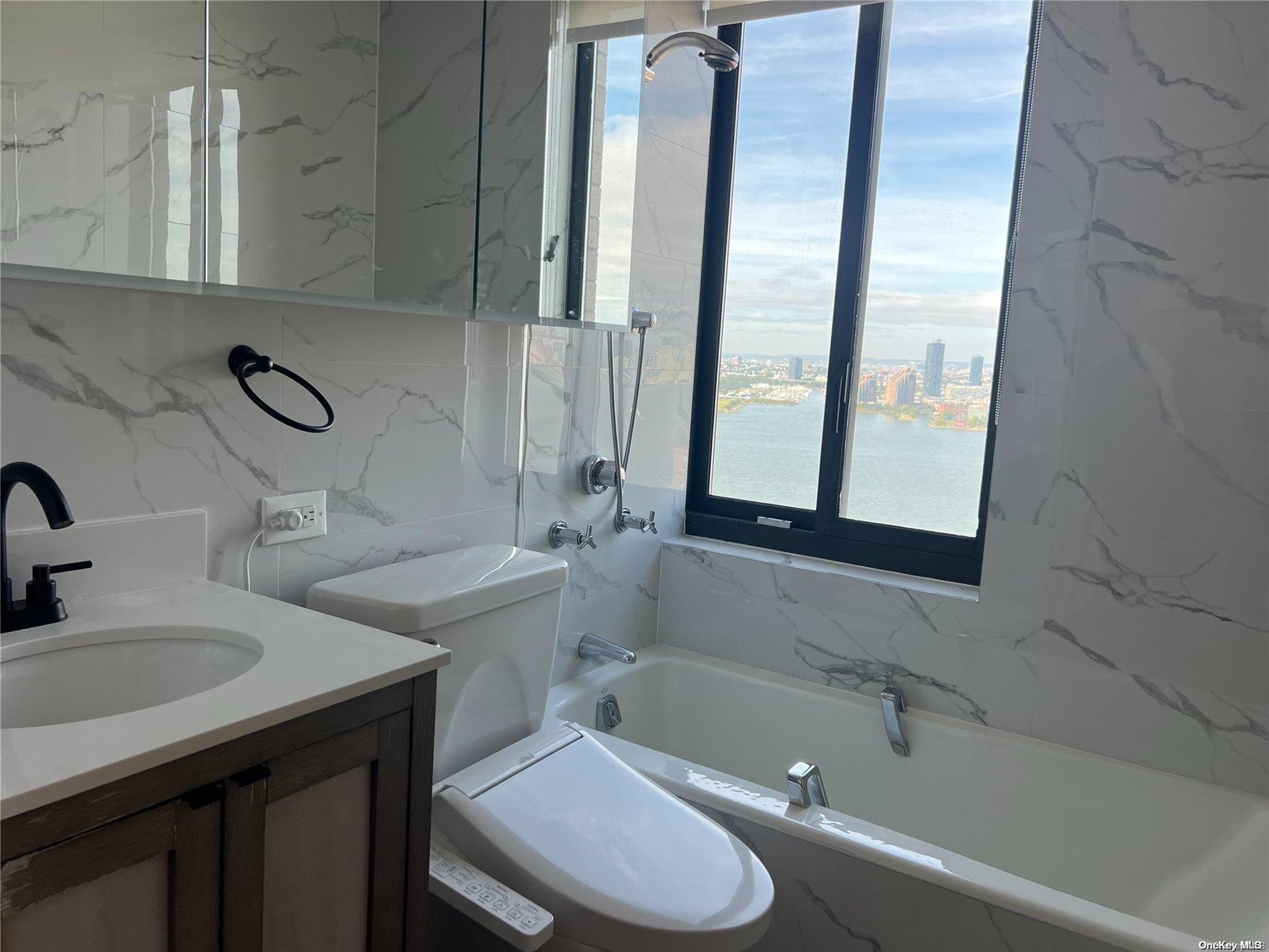200 Rector Place, Unit 35E Manhattan, NY 10280 - Photo 5 of 33 a bathroom with a sink and a bathtub