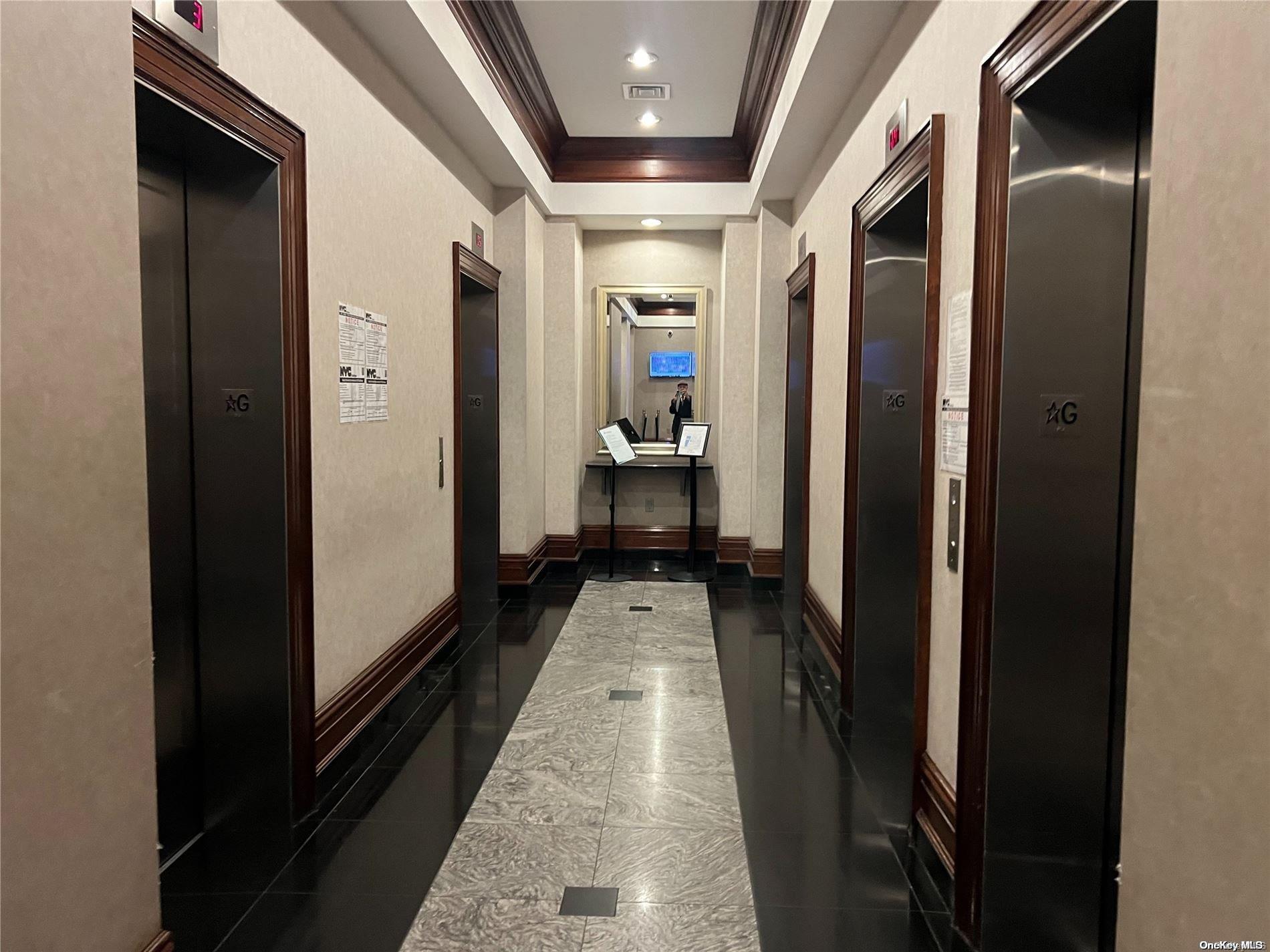 200 Rector Place, Unit 35E Manhattan, NY 10280 - Photo 9 of 33 a hallway with wooden floor