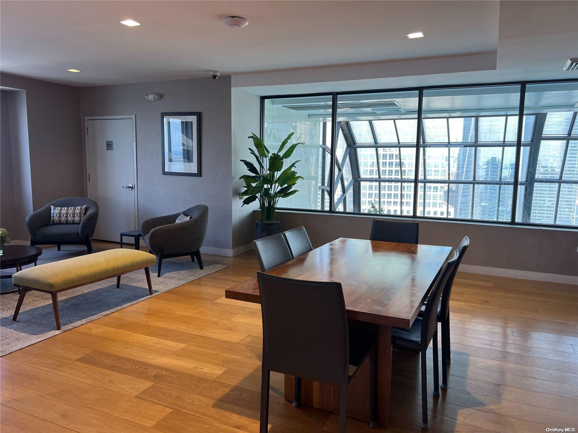 200 Rector Place, Unit 35E Manhattan, NY 10280 - Photo 10 of 33 a view of a dining room with furniture window and wooden floor