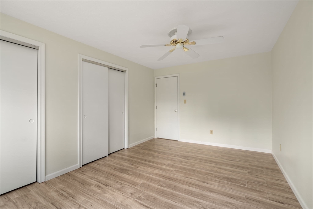 1325 Worcester Road, Unit A11 Framingham, MA 01701 - Photo 11 of 18 a view of an empty room with wooden floor